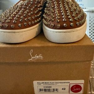 Authentic Christian Louboutin Roller-Boat Flat sneakers featuring the iconic red